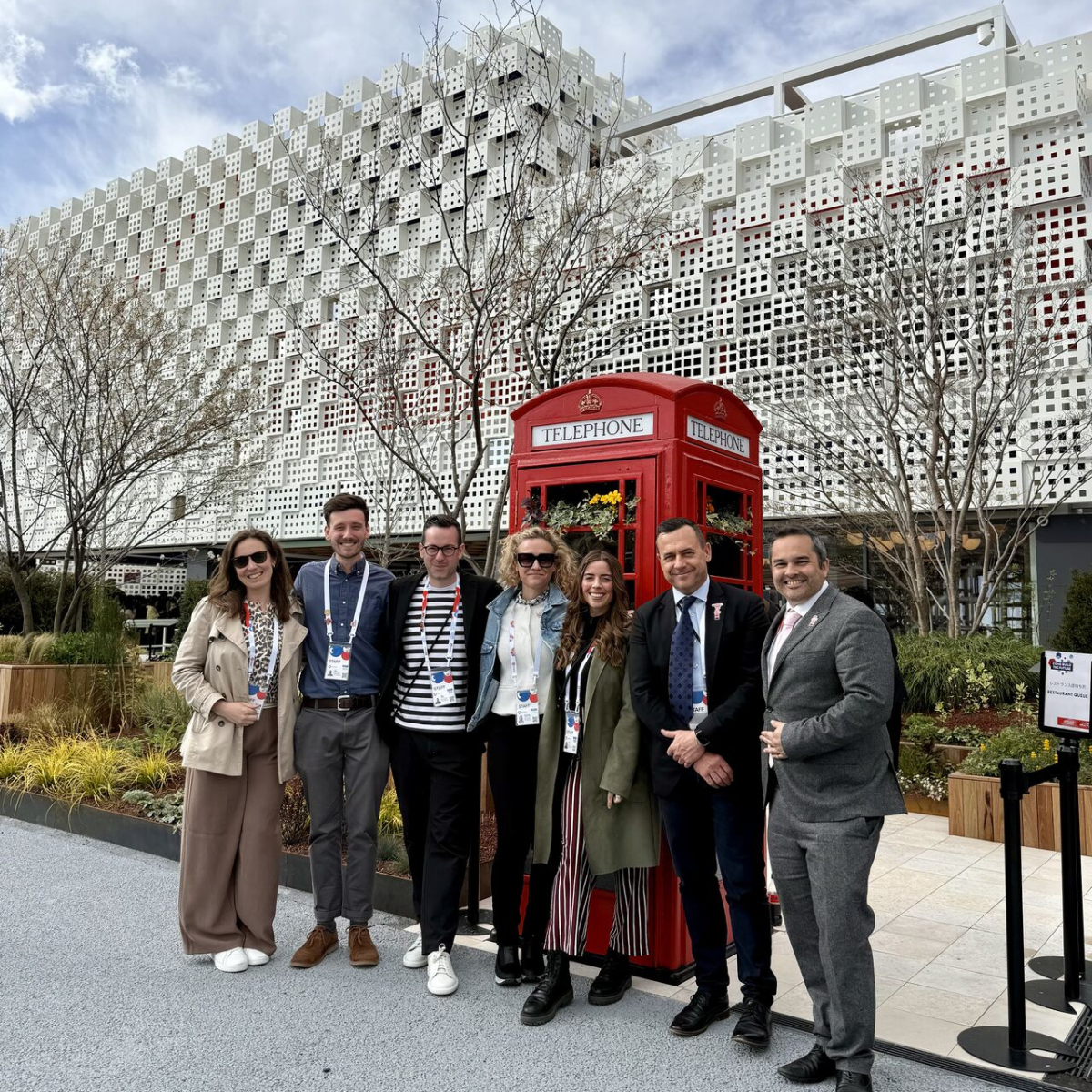 The wider team in front of the Expo building and phone box